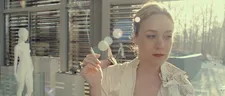 Chloë Sevigny as Alex in a kimono, sprouting kite-like flowers.